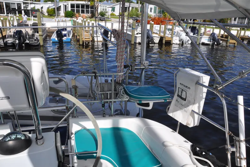 Slide: The Image of Cockpit view of 2003 Catalina 387 sailboat docked at marina with life ring and seating. - 19