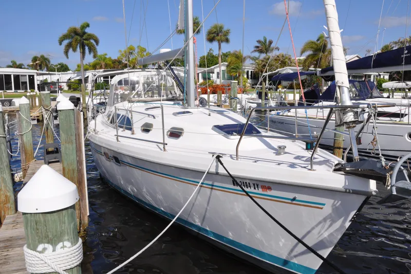 Slide: The Image of Catalina 387 sailboat docked at marina, 2003 model, surrounded by palm trees and clear skies. - 2