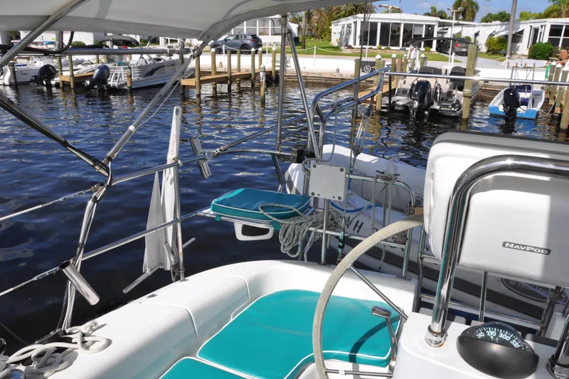 Slide: The Image of Cockpit view of 2003 Catalina 387 sailboat docked at marina with turquoise seating. - 20