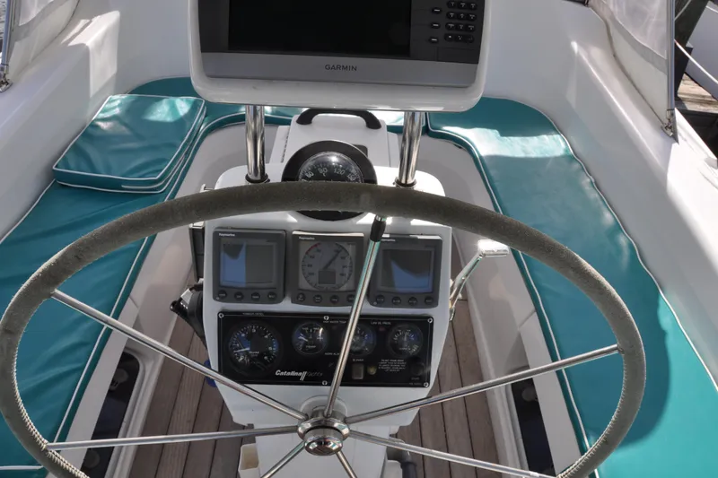 Slide: The Image of Cockpit of 2003 Catalina 387 sailboat with steering wheel and navigation instruments. - 21