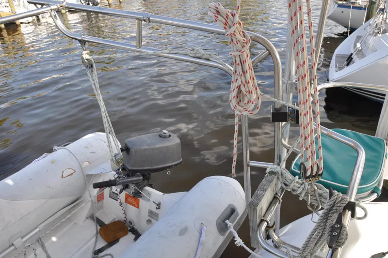 Slide: The Image of Catalina 387 sailboat, 2003 model, with ropes and dinghy motor at dockside. - 25