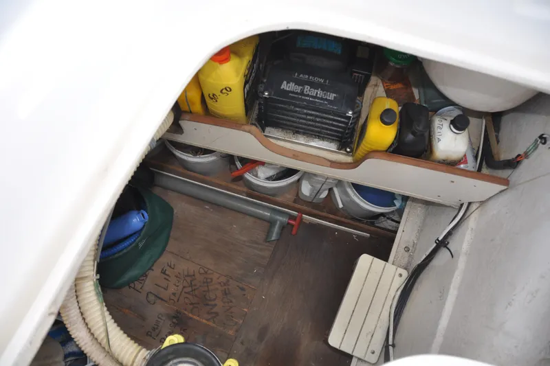 Slide: The Image of Storage compartment in a 2003 Catalina 387 sailboat with various maintenance supplies. - 26