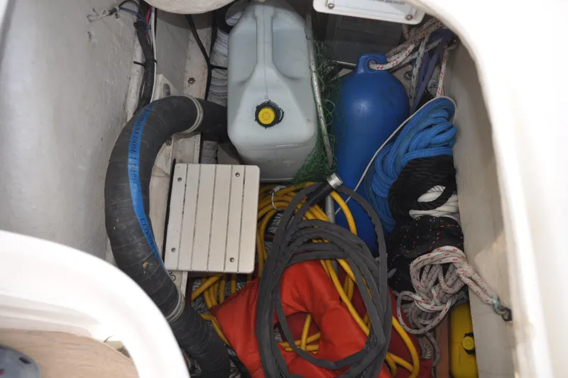 Slide: The Image of Storage compartment in a 2003 Catalina 387 sailboat with ropes, fender, and equipment. - 29