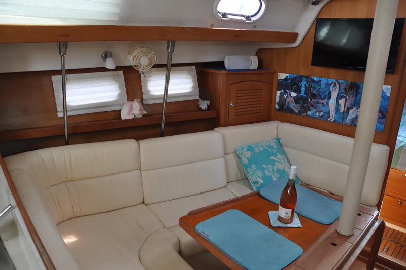 Slide: The Image of Interior of 2003 Catalina 387 yacht with cozy seating and table setup. - 32