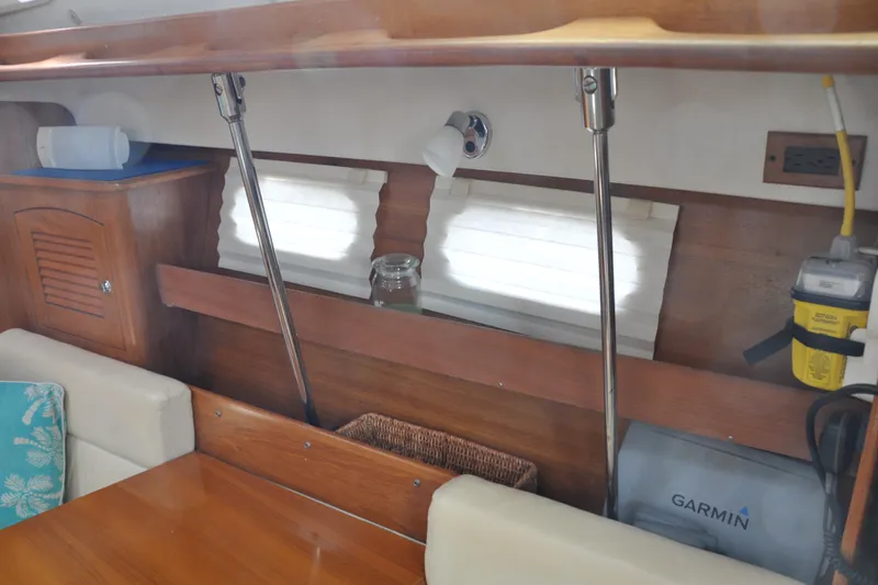 Slide: The Image of Interior of a 2003 Catalina 387 sailboat with wooden cabinetry and nautical equipment. - 35
