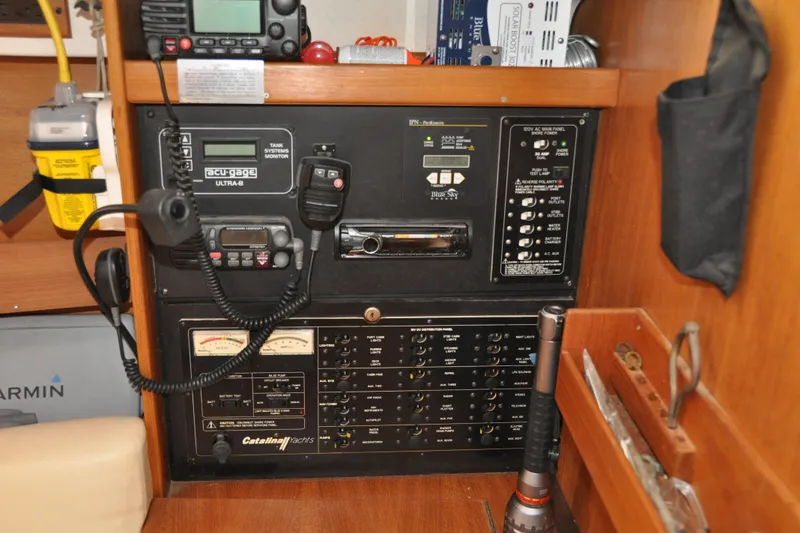 Slide: The Image of Electrical control panel in a 2003 Catalina 387 yacht, featuring communication and monitoring equipment. - 38