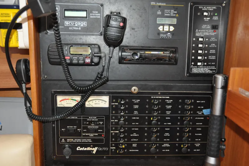 Slide: The Image of Control panel of a 2003 Catalina 387 yacht with various gauges and switches. - 39