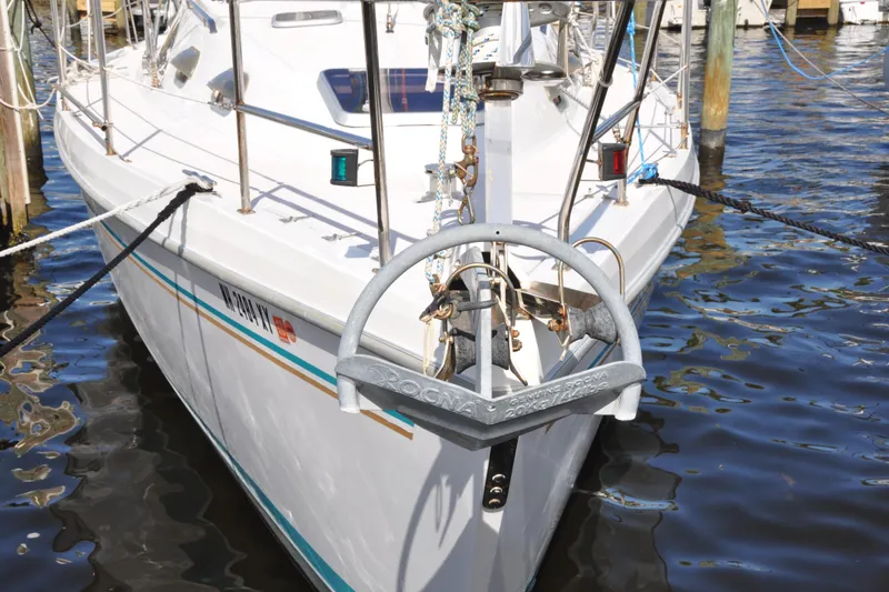 Slide: The Image of Catalina 387 sailboat from 2003 docked with Rocna anchor, reflecting on water. - 4