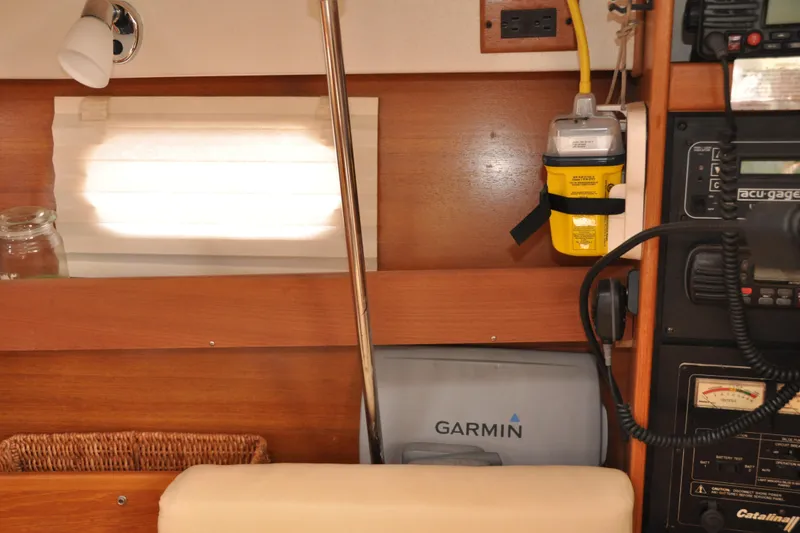 Slide: The Image of Interior of a 2003 Catalina 387 sailboat with navigation equipment and wooden paneling. - 42