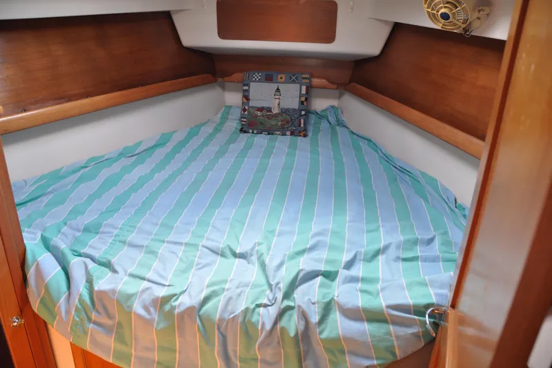 Slide: The Image of Cozy cabin interior of 2003 Catalina 387 sailboat with striped bedding. - 43