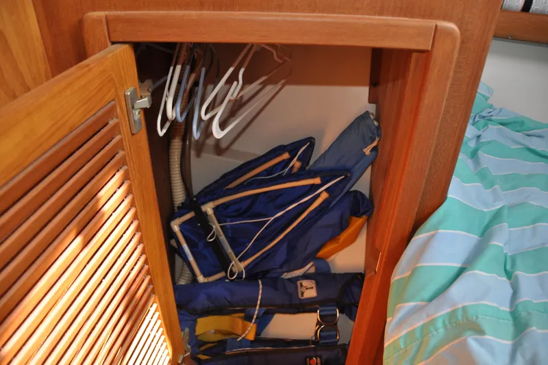 Slide: The Image of Wooden closet on Catalina 387 yacht with life jackets and hangers, 2003 model. - 47