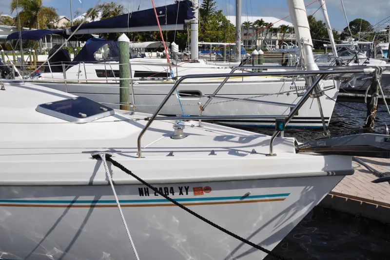 Slide: The Image of Catalina 387 sailboat from 2003 docked at a marina, featuring sleek design and vibrant accents. - 5