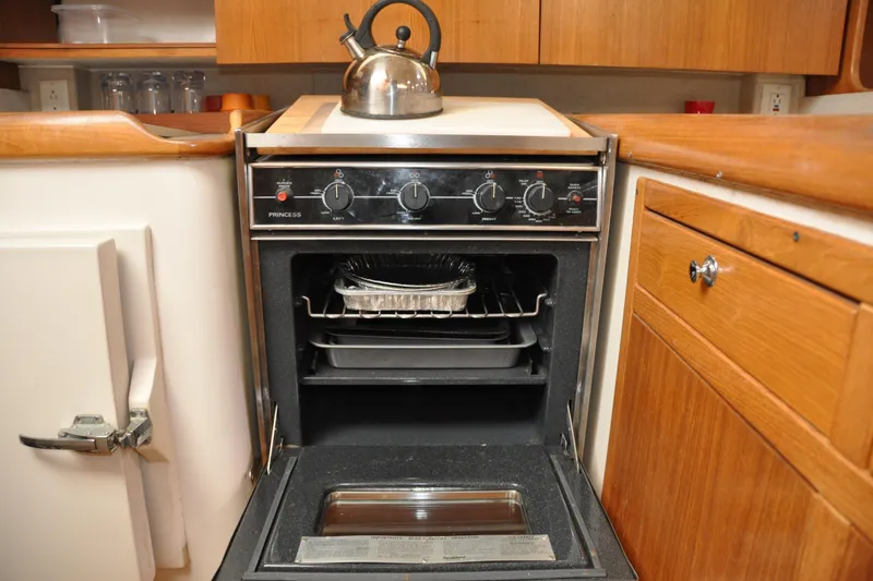 Slide: The Image of Compact kitchen oven with kettle, inside a 2003 Catalina 387 sailboat galley. - 53