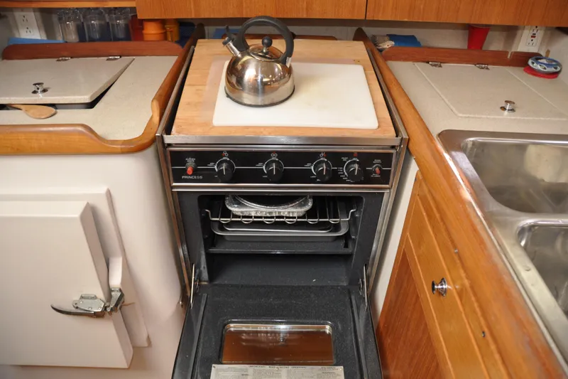 Slide: The Image of Compact kitchen in a 2003 Catalina 387 yacht with stove and kettle. - 54