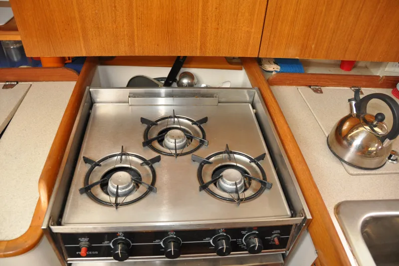 Slide: The Image of Three-burner stove in 2003 Catalina 387 yacht kitchen with kettle nearby. - 59