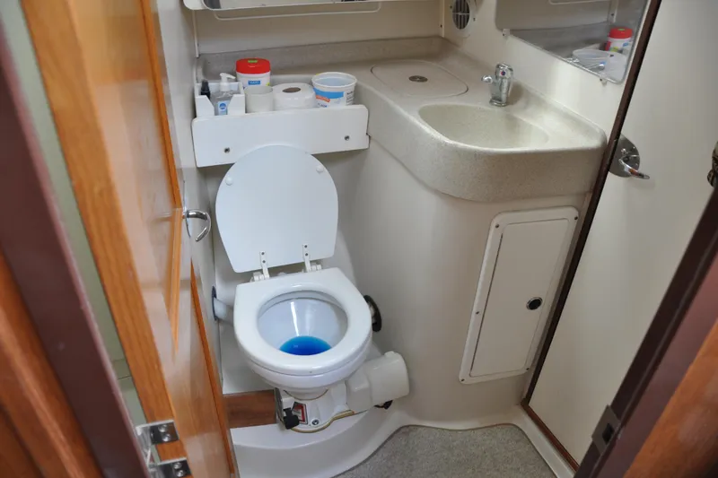 Slide: The Image of Compact bathroom in a 2003 Catalina 387 yacht with toilet and sink. - 62
