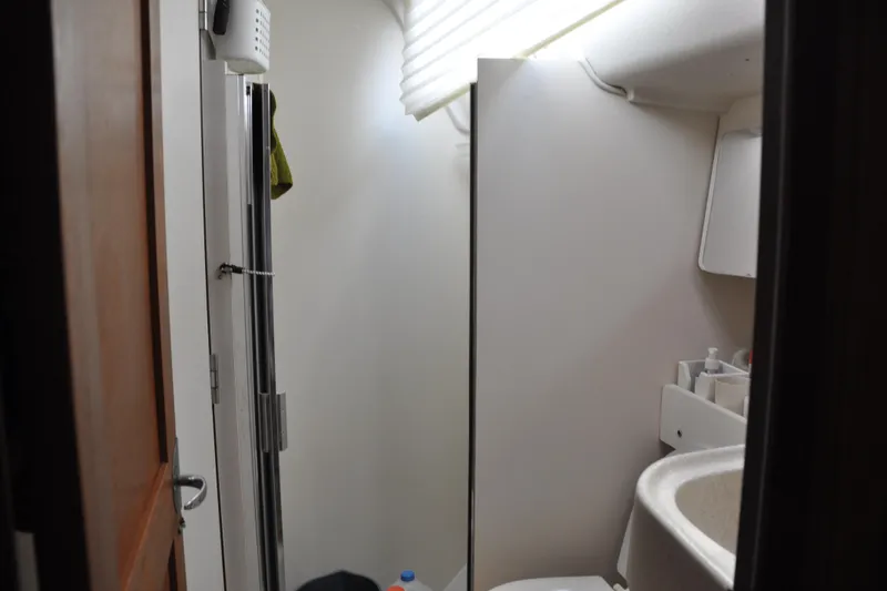 Slide: The Image of Compact bathroom interior of a 2003 Catalina 387 yacht with shower and sink. - 64