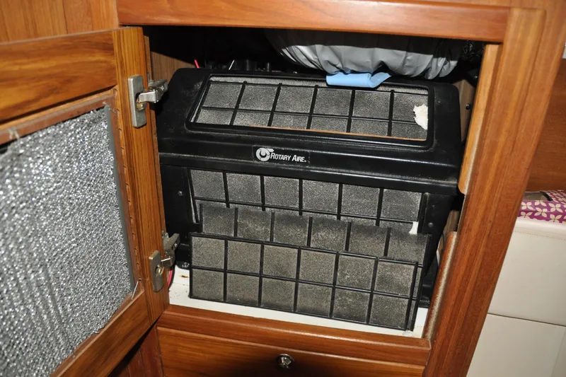 Slide: The Image of Air conditioning unit inside a wooden cabinet on a 2003 Catalina 387 boat. - 65