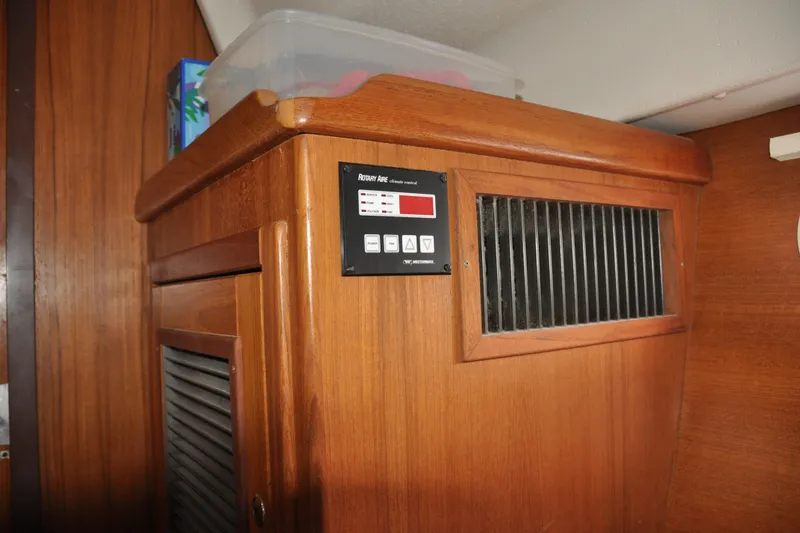 Slide: The Image of Wooden interior of a 2003 Catalina 387 yacht with air vent and control panel. - 66