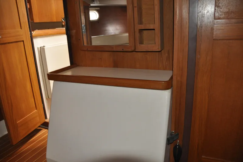 Slide: The Image of Interior of 2003 Catalina 387 sailboat with wooden cabinetry and foldable table. - 67