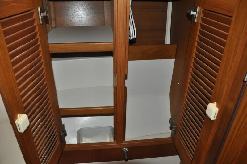 Slide: The Image of Wooden cabinet interior with shelves in a 2003 Catalina 387 model. - 68