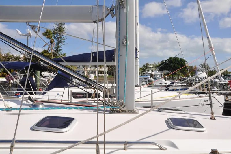 Slide: The Image of Sailboats docked at marina, featuring a 2003 Catalina 387 under clear skies. - 7