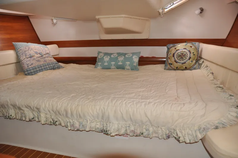 Slide: The Image of Cozy cabin interior of 2003 Catalina 387 sailboat with plush bedding and decorative pillows. - 72
