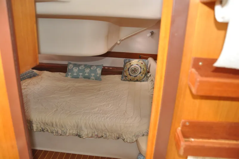 Slide: The Image of Cozy cabin interior of 2003 Catalina 387 sailboat with decorative pillows and wooden accents. - 73