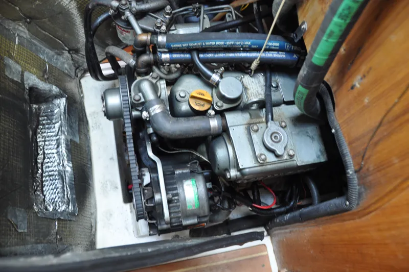 Slide: The Image of Engine compartment of a 2003 Catalina 387 sailboat, showcasing mechanical components and hoses. - 75