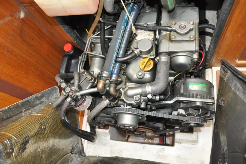 Slide: The Image of Engine compartment of a 2003 Catalina 387 sailboat, showcasing mechanical components and hoses. - 76