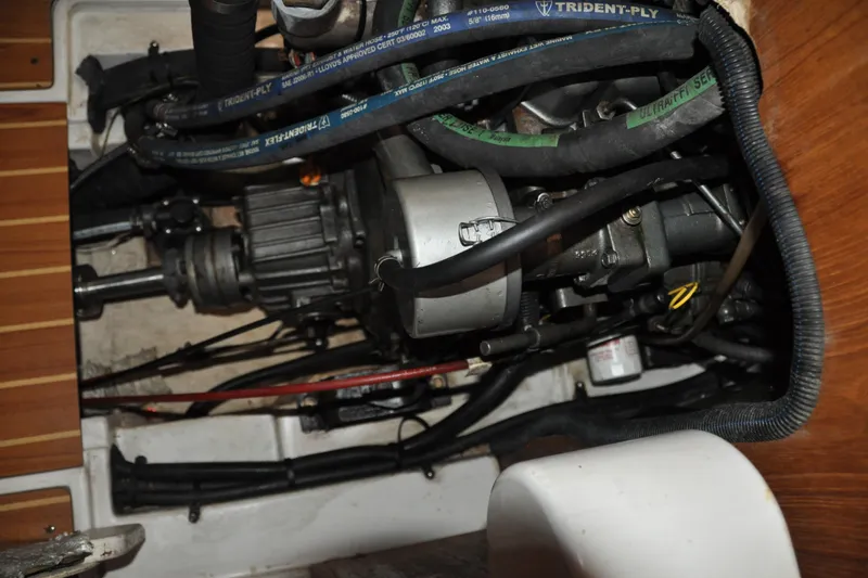 Slide: The Image of Engine compartment of a 2003 Catalina 387 sailboat, showing mechanical components and hoses. - 78