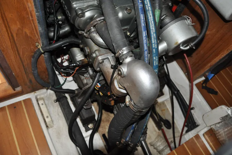 Slide: The Image of Engine compartment of a 2003 Catalina 387 sailboat, showing hoses and mechanical components. - 80