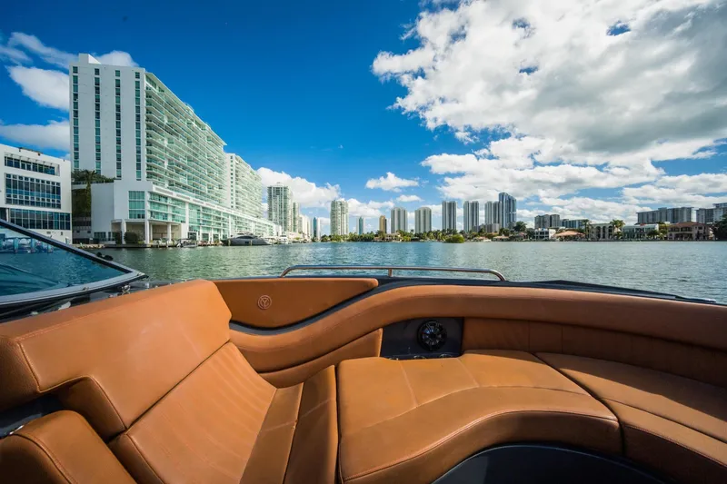 Slide: The Image of 2017 Cruisers Sport Series 298 Bow Rider on water with city skyline. - 19