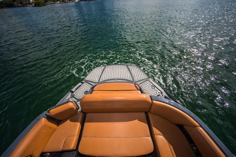 Slide: The Image of 2017 Cruisers Sport Series 298 Bow Rider on water, featuring tan seating. - 24