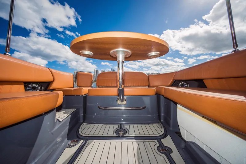 Slide: The Image of Luxurious interior of 2017 Cruisers Sport Series 298 Bow Rider, featuring leather seating and table. - 25