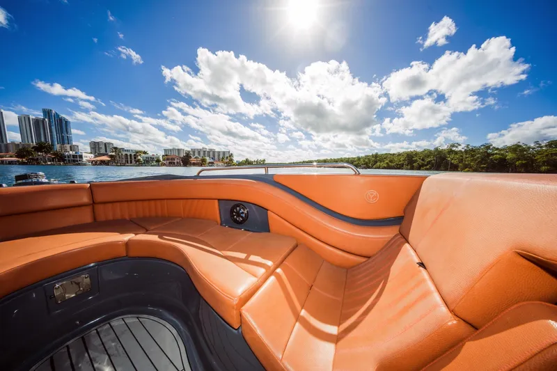 Slide: The Image of Luxurious 2017 Cruisers Sport Series 298 Bow Rider with orange seating under sunny skies. - 28