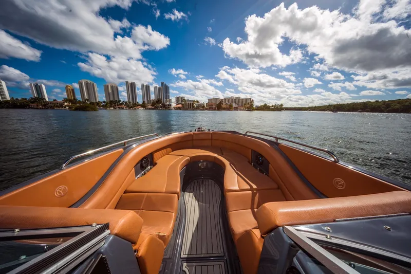 Slide: The Image of 2017 Cruisers Sport Series 298 Bow Rider on water with city skyline. - 29