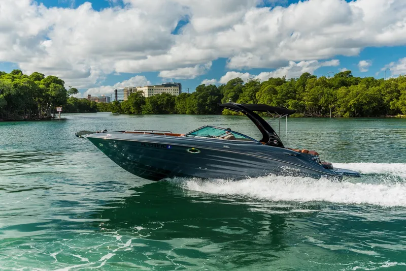 Slide: The Image of 2017 Cruisers Sport Series 298 Bow Rider South Beach Edition cruising on a scenic waterway. - 5