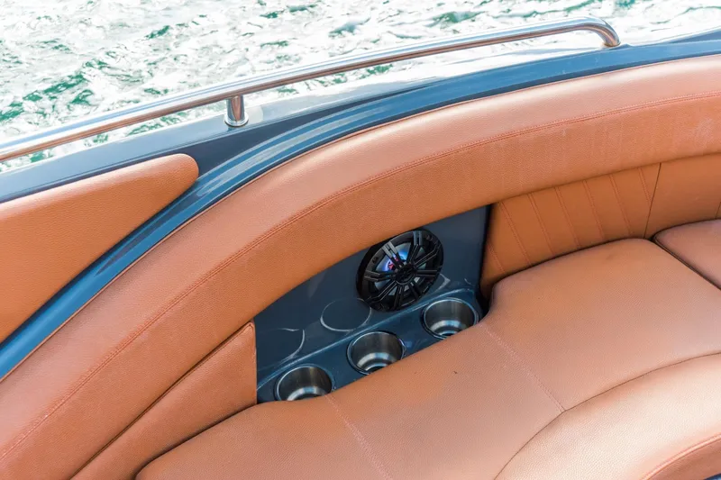 Slide: The Image of Luxurious seating on 2017 Cruisers Sport Series 298 Bow Rider, featuring cup holders and speaker. - 6