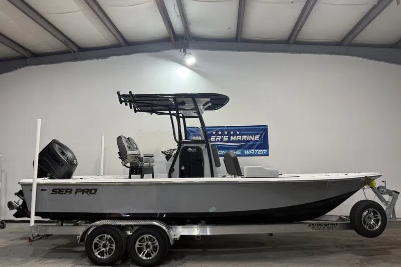 The Image of 2026 Sea Pro 230 Bay boat on trailer in indoor showroom. - 0