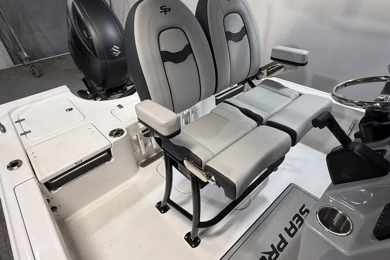 Slide: The Image of 2026 Sea Pro 230 Bay boat interior with dual seats and steering console. - 10