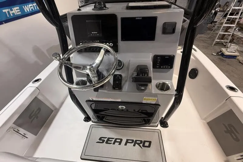 Slide: The Image of 2026 Sea Pro 230 Bay boat console with steering wheel and electronic controls. - 14