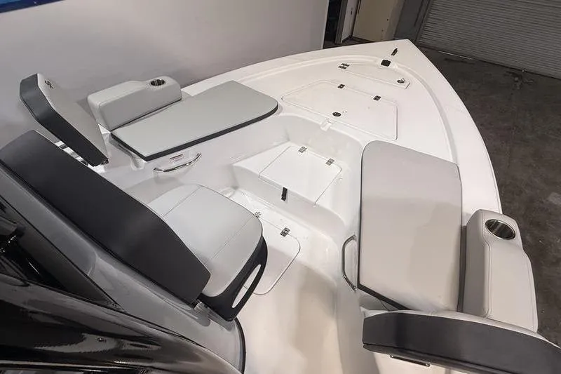 Slide: The Image of Interior view of 2026 Sea Pro 230 Bay boat with cushioned seating and storage compartments. - 21