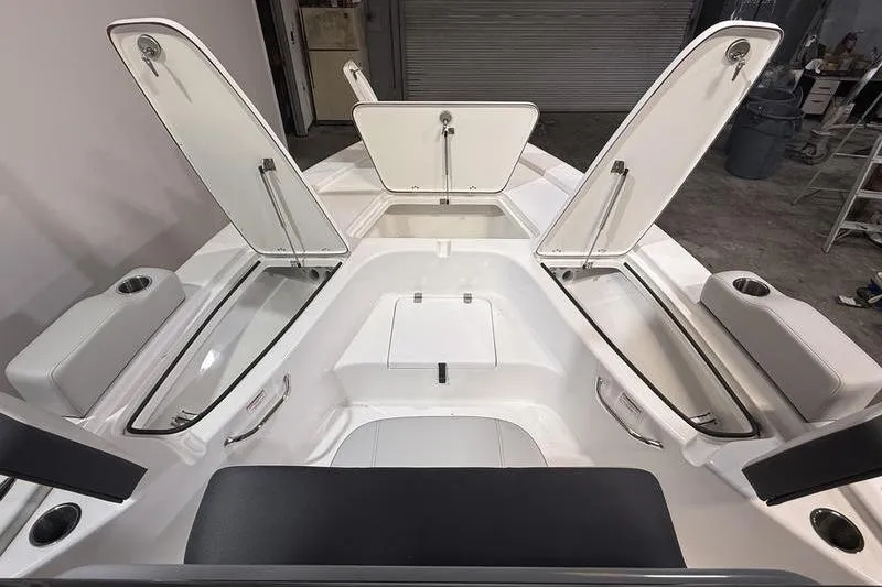 Slide: The Image of 2026 Sea Pro 230 Bay boat interior with open storage compartments and seating. - 22
