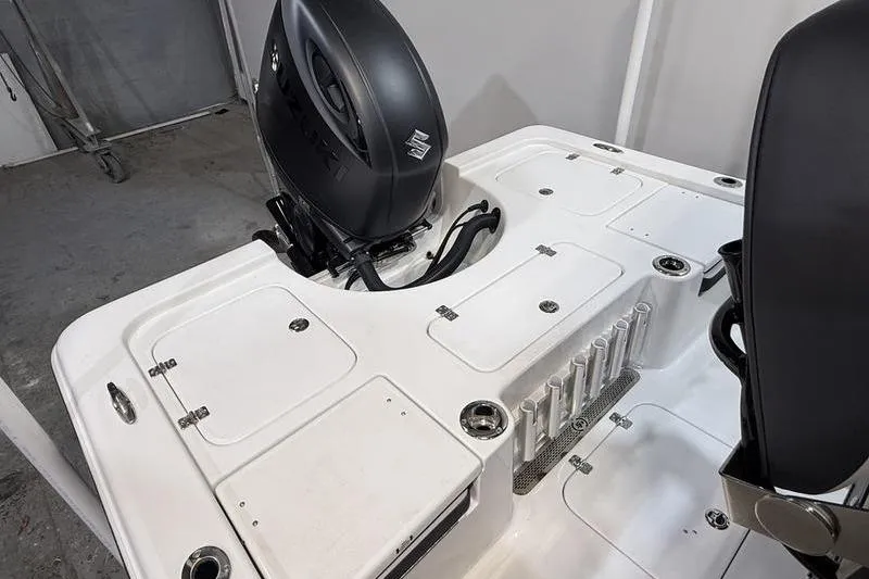 Slide: The Image of 2026 Sea Pro 230 Bay boat deck with motor and storage compartments. - 7