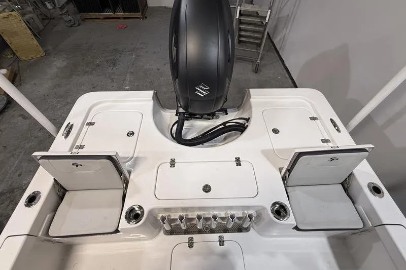 Slide: The Image of 2026 Sea Pro 230 Bay boat deck with storage compartments and motor. - 8