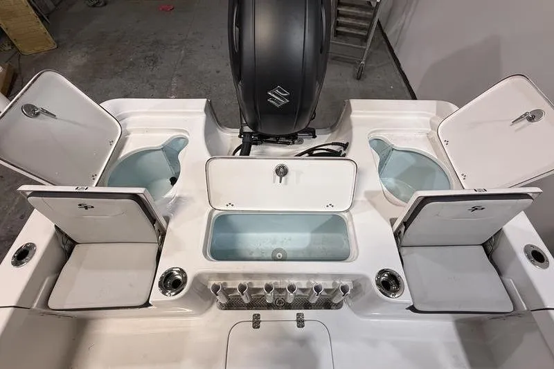 Slide: The Image of 2026 Sea Pro 230 Bay boat deck with storage compartments and motor. - 9