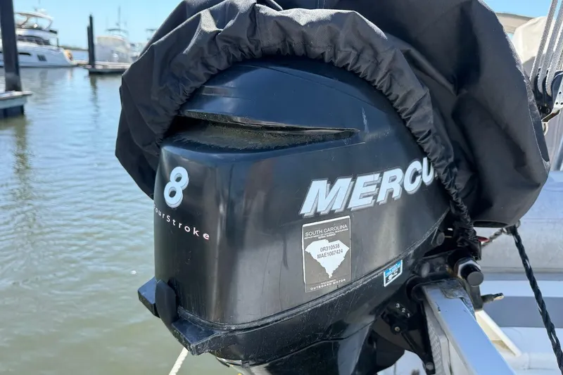 Slide: The Image of Mercury 8 FourStroke outboard motor on a Catalina 380, 1998 model, docked at marina. - 22