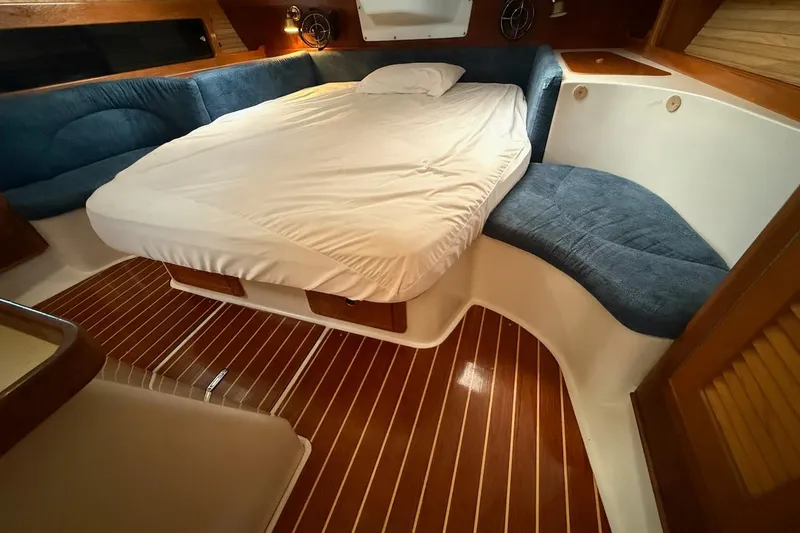 Slide: The Image of Cozy cabin interior of 1998 Catalina 380 sailboat with wooden flooring and comfortable bedding. - 34