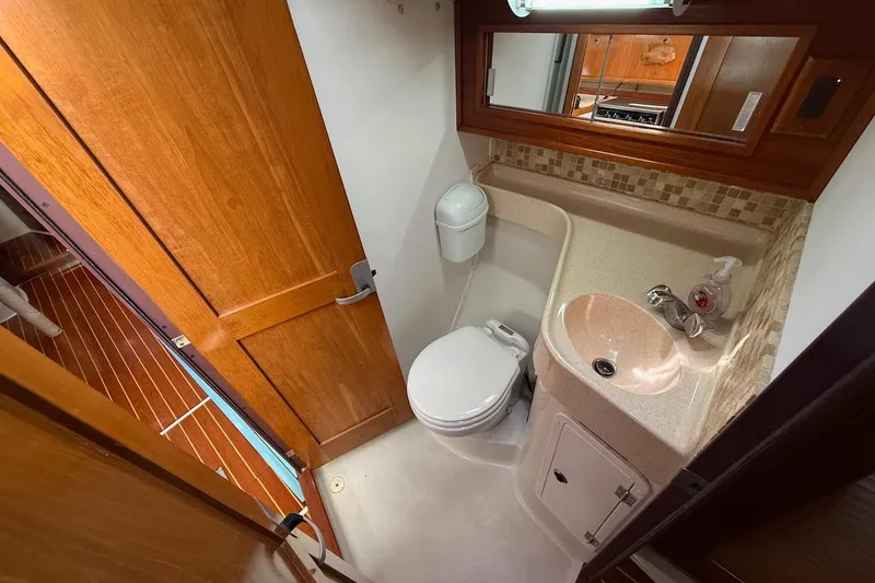 Slide: The Image of Bathroom interior of a 1998 Catalina 380 yacht, featuring wood accents and compact design. - 37